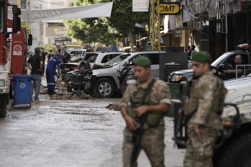 Lebanese soldiers stand guard near the site of Friday's Israeli strike in Beirut's southern suburb, Sunday, Sept. 22, 2024. (AP Photo/Bilal Hussein)