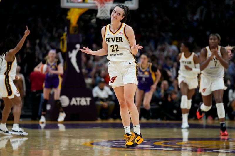 Indiana Fever guard Caitlin Clark (22) celebrates after making a 3-pointer during the second half of a WNBA basketball game against the Los Angeles Sparks in Los Angeles, Friday, May 24, 2024. (AP Photo/Ashley Landis)