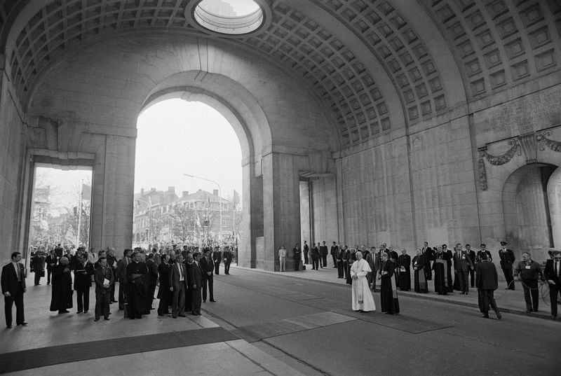 FILE -- Pope John Paul II stands underneath the huge bow of the Menen Gate, a war memorial for the dead of World War II, in Ieper, May 17, 1985, on his second day in Belgium. (AP Photo, File)