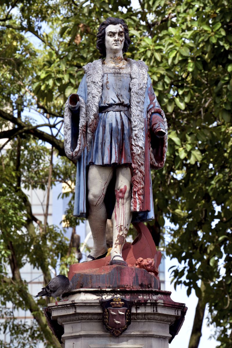 The vandalized statue of Christopher Columbus stands in Columbus Square in Port of Spain, Trinidad and Tobago, Wednesday, Aug. 28, 2024. Officials in the Caribbean island nation are reviewing on whether to remove statues, signs and monuments that reference European colonization. (AP Photo/Robert Taylor)