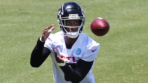 Falcons tight end Kyle Pitts (center) catches a pass while running a drill during rookie minicamp on Friday, May 14, 2021, in Flowery Branch. (Curtis Compton / Curtis.Compton@ajc.com)