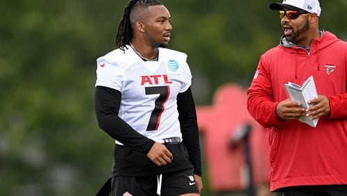 Atlanta Falcons running back Bijan Robinson (7) talks with a coaching staff during day 1 of Atlanta Falcons Training Camp on Thursday, July 25, 2024 in Flowery Branch. (Hyosub Shin / AJC)