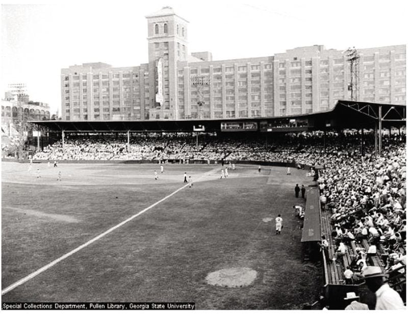 Ponce de Leon Park, where the Atlanta Crackers played from 1907 to 1964, is seen with the old Sears building (now Ponce City Market) in the background. The park was the site of the first Billy Graham Crusade in Atlanta in 1950. The park was demolished in 1966 but its signature magnolia tree remains near the railroad tracks that ran past the old ballpark's outfield area.