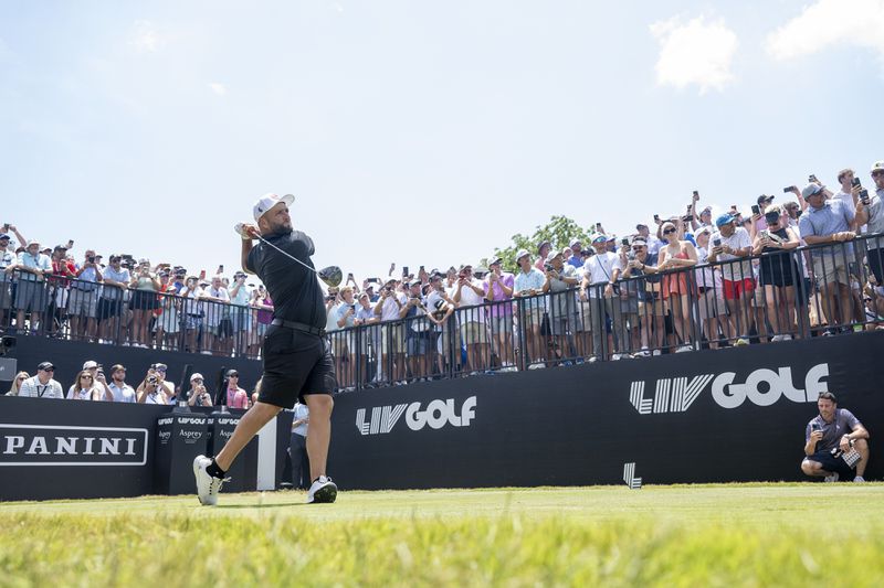 Captain Jon Rahm, of Legion XIII, hits from the first tee during the final round of LIV Golf Nashville at The Grove, Sunday, June 23, 2024, in College Grove, Tenn. (Charles Laberge/LIV Golf via AP)