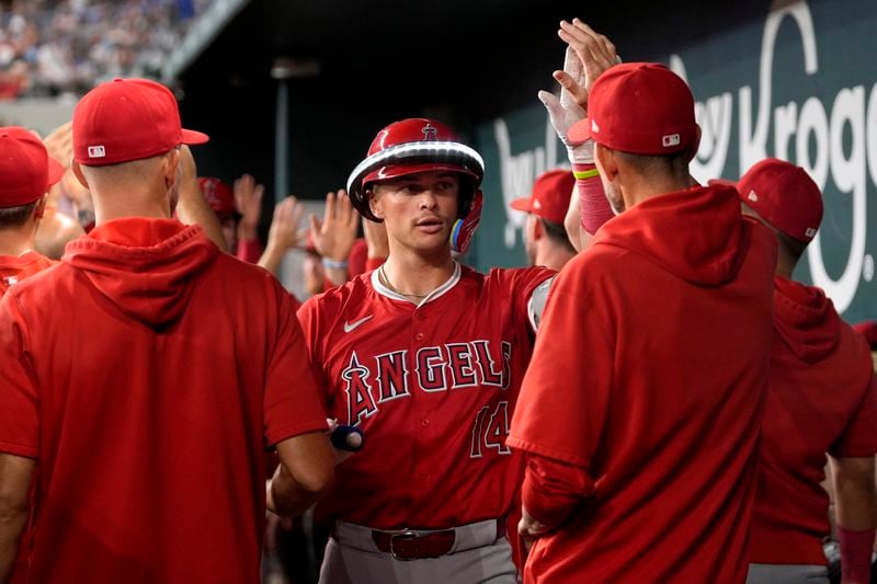 Los Angeles Angels' Logan O'Hoppe (14) celebrates in the dugout after hitting a three-run home run against the Texas Rangers in the sixth inning of a baseball game Friday, Sept. 6, 2024, in Arlington, Texas. (AP Photo/Tony Gutierrez)