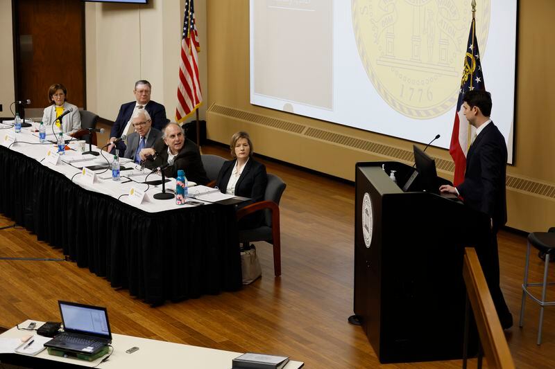 Georgia State Election Board members listen to Ryan Germany, a former attorney for Republican Secretary of State Brad Raffensperger, during a board meeting Tuesday at Mercer University in Macon. Germany also participated in a performance review of Fulton County elections. Miguel Martinez / miguel.martinezjimenez@ajc.com