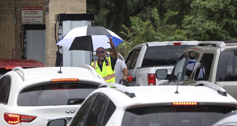 Cars wait in line to get into the parking lot for gas at Costco, Monday, Oct. 7, 2024, in Altamonte Springs, Fla., as residents prepare for the impact of approaching Hurricane Milton. (Joe Burbank/Orlando Sentinel via AP)