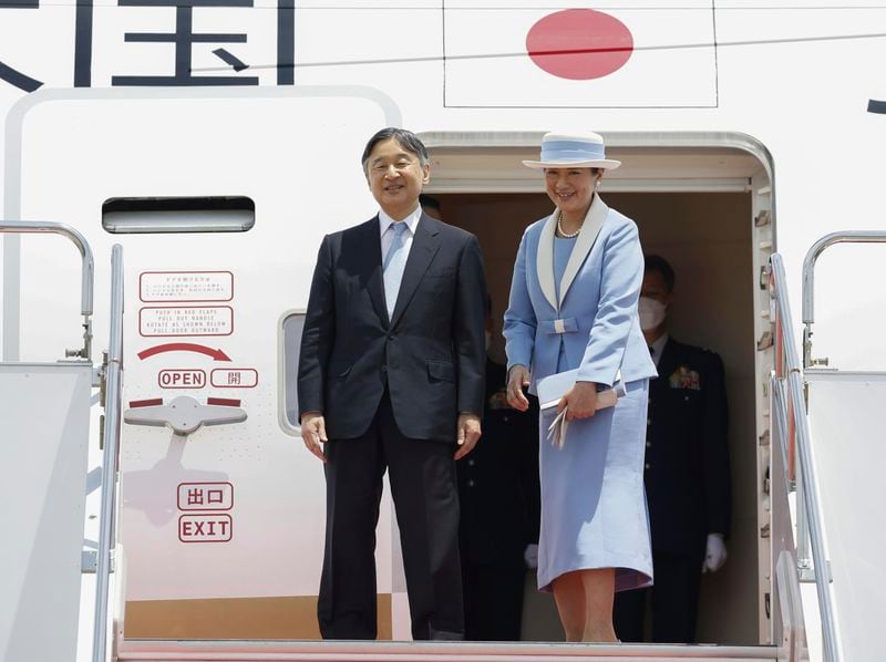 Japanese Emperor Naruhito, left, and Empress Masako smile as they depart for the state visit to Britain, at Haneda airport in Tokyo, Japan, Saturday, June 22, 2024. (Kyodo News via AP)