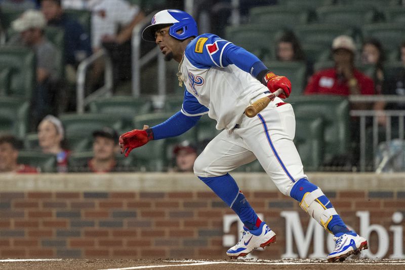 Atlanta Braves' Ozzie Albies watches his hit in the infield in the first inning of a baseball game against the Kansas City Royals, Saturday, Sept. 28, 2024, in Atlanta. (AP Photo/Jason Allen)