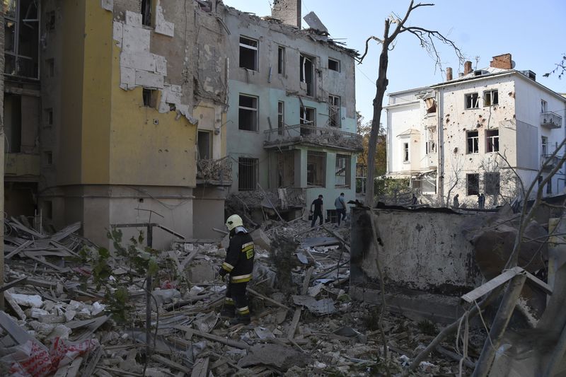 Rescuers search for victims in an apartment building destroyed by Russian missile attack in centre Lviv, Western Ukraine, Wednesday Sept. 4, 2024. (AP Photo/Mykola Tys)