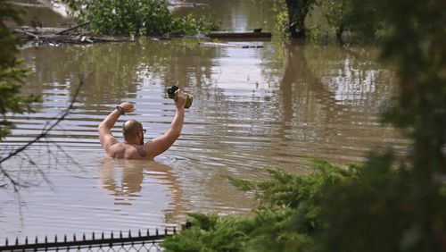 A man wades through flood water in Opava, Czech Republic, Sunday Sept. 15, 2024. (Jaroslav Ozana/CTK via AP)