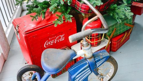 Vintage picnic tins, thermoses and coolers serve as an unexpected tree skirt. Author Kathy Hogan Trocheck says her holiday decorations remind her of what if would look like if Ralph Lauren were trapped in a 1950s Woolworth.