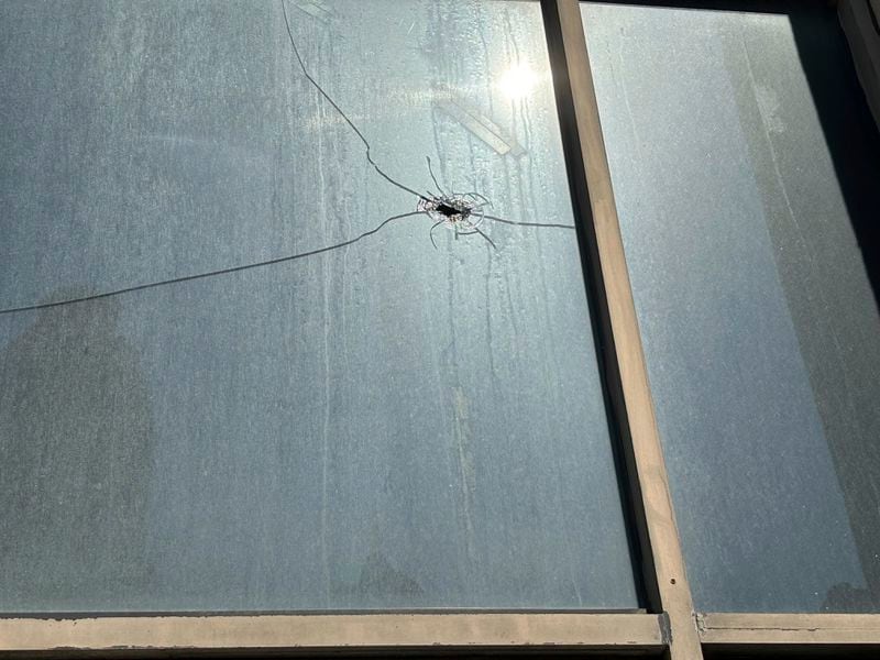 What appears to be a bullet hole is visible in the window of Hush, a hookah and cigar lounge, in Birmingham, Ala. on Sept. 24, 2024, the day after a mass shooting took place. (AP Photo/Kim Chandler)