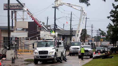 FILE - Utility crews work to restore electricity in Houston, Thursday, July 11, 2024. As of Thursday, July 18, most Houston residents finally had electricity after more than a week of widespread outages. (AP Photo/Lekan Oyekanmi, File)