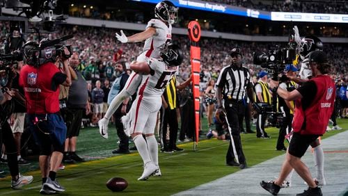 Atlanta Falcons wide receiver Drake London (5) celebrates his touchdown with Atlanta Falcons guard Chris Lindstrom (63) during the second half of an NFL football game against the Philadelphia Eagles on Monday, Sept. 16, 2024, in Philadelphia. (AP Photo/Matt Rourke)