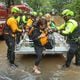 Atlanta fire rescue came to the aid of Hyde Manor Drive residents Friday morning. Here, Maggie Blease and her daughter, Audrey, 12, were ferried to safety. Hurricane Helene brought heavy rain and high winds across Georgia. 