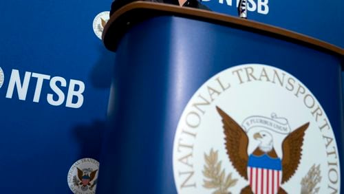 FILE - The National Transportation Safety Board logo and signage are seen at a news conference at NTSB headquarters in Washington, Dec. 18, 2017. Investigators said Thursday, June 6, 2024, that an incoming FedEx cargo plane came within less than 200 feet of hitting a Southwest Airlines jet last year in Austin, Texas, after both were cleared to use the same runway. (AP Photo/Andrew Harnik, File)