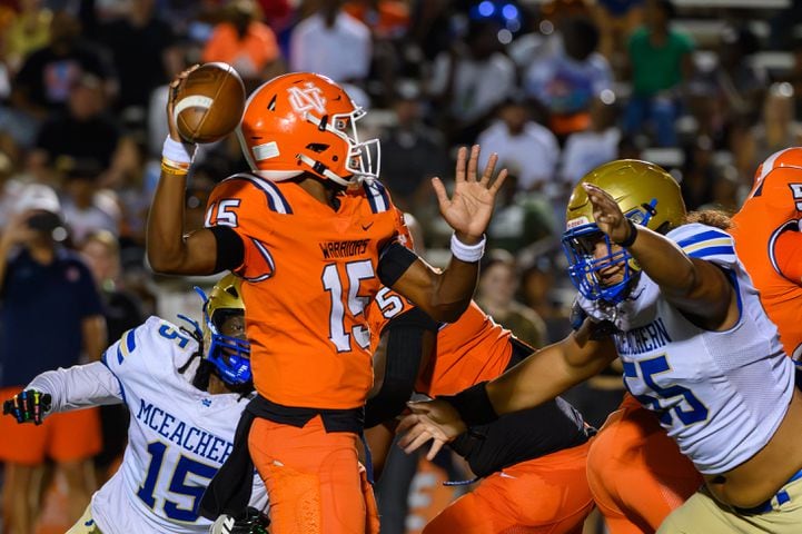 Nick Grimstead, quarterback for North Cobb, narrowly escapes a sack during the football game against McEachern in Kennesaw, GA on August 23, 2024 (Jamie Spaar for the Atlanta Journal Constitution)