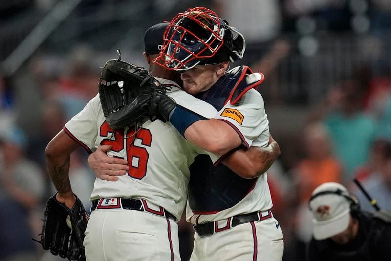 Atlanta Braves reliever Raisel Iglesias (26) celebrates the last stike with Atlanta Braves catcher Sean Murphy (12) after the nineth inning of a baseball game against the Philadelphia Phillies, Thursday, Aug. 22, 2024, in Atlanta. (AP Photo/Mike Stewart)