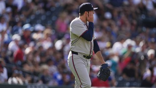 Atlanta Braves relief pitcher Luke Jackson reacts after giving up a two-run home run to Colorado Rockies' Jake Cave in the eighth inning of a baseball game Sunday, Aug. 11, 2024, in Denver. (AP Photo/David Zalubowski)