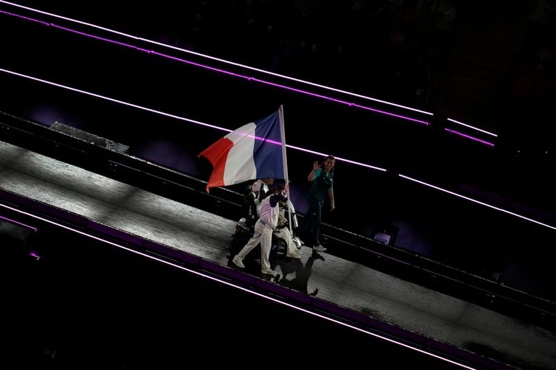 Members of the French delegation parade during the closing ceremony of the 2024 Paralympics, Sunday, Sept. 8, 2024, in Paris, France. (AP Photo/Christophe Ena)