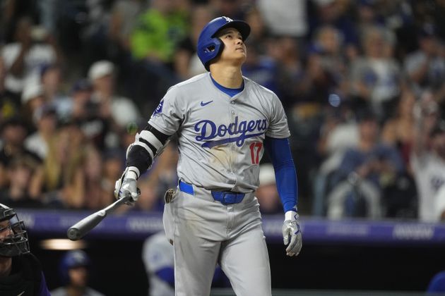 Los Angeles Dodgers' Shohei Ohtani watches the flight of his three-run home run off Colorado Rockies relief pitcher Anthony Molina in the sixth inning of a baseball game Friday, Sept. 27, 2024, in Denver. (AP Photo/David Zalubowski)