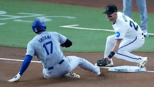 Los Angeles Dodgers' Shohei Ohtani (17) of Japan, steals third base as Miami Marlins third baseman Connor Norby attempts the tag during the first inning of a baseball game, Thursday, Sept. 19, 2024, in Miami. (AP Photo/Wilfredo Lee)