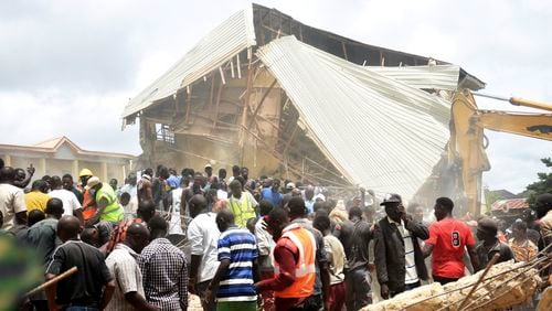 People and rescuers gather at the scene of a collapsed two-storey building in Jos, Nigeria, Friday, July, 12, 2024. At least 12 students have been killed after a school building collapsed and trapped them in northern Nigeria, authorities said on Friday. (AP Photos)