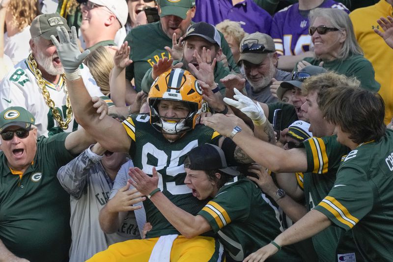 Green Bay Packers tight end Tucker Kraft (85) celebrates a touchdown with fans during the second half of an NFL football game against the Minnesota Vikings, Sunday, Sept. 29, 2024, in Green Bay, Wis. (AP Photo/Morry Gash)