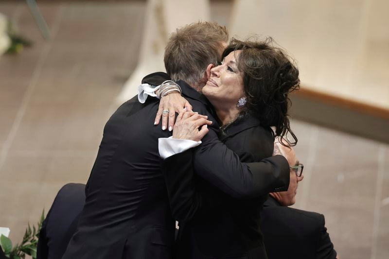 David Beckham and Nancy Dell'Olio hug as they arrive to attend the funeral service of Swedish soccer manager Sven-Goran Eriksson at Fryksände church in Torsby, Sweden, Friday Sept. 13, 2024. (Adam Ihse/TT News Agency via AP)