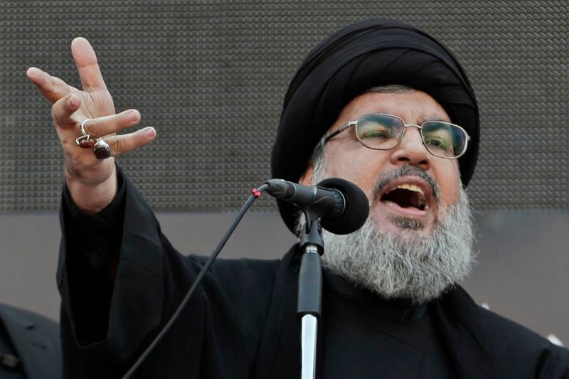 FILE - Hezbollah leader Sheik Hassan Nasrallah, speaks to the crowd in a rare public appearance during Ashura, that marks the death of Shiite Islam's Imam Hussein, in the suburbs of Beirut, Nov. 14, 2013. (AP Photo/Bilal Hussein, File)