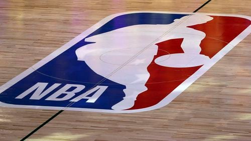 FILE - An NBA logo is seen at center court prior to an NBA basketball game between the Los Angeles Clippers and the Los Angeles Lakers, Thursday, July 30, 2020, in Lake Buena Vista, Fla. The NBA has agreed to terms on its new media deal, an 11-year agreement worth $76 billion that assures player salaries will continue rising for the foreseeable future and one that will surely change how some viewers access the game for years to come. (Mike Ehrmann/Getty Images via AP, Pool, File)
