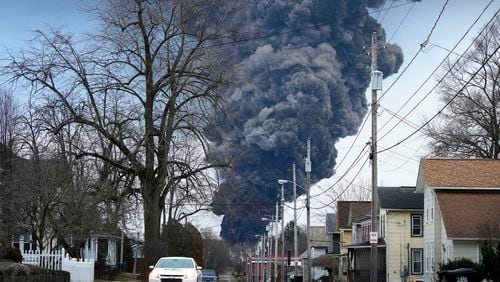 FILE - A black plume rises over East Palestine, Ohio, as a result of a controlled detonation of a portion of the derailed Norfolk Southern trains, Feb. 6, 2023. A watchdog group says the Environmental Protection Agency should have conducted additional soil studies around the site of the derailment and tested garden crops after independent testing found high levels of chemicals in locally grown garlic. The Government Accountability Project filed a formal petition on Thursday, June 13, 2024 with the EPA. (AP Photo/Gene J. Puskar, file)