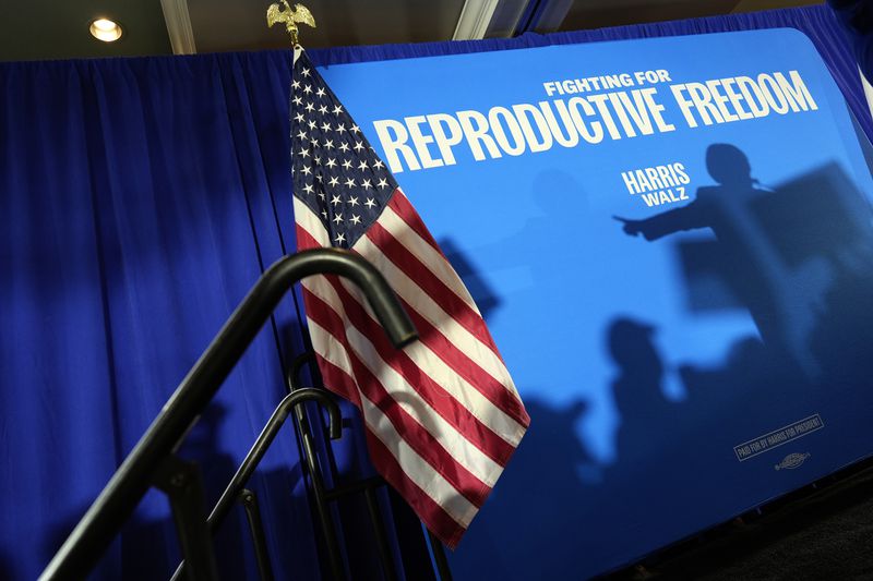 The shadow of Sen. Amy Klobuchar, D-Minn., is cast on a backdrop as she speaks at an event kicking off a national "Reproductive Freedom Bus Tour" by the campaign of Democratic presidential nominee Vice President Kamala Harris and running mate Gov. Tim Walz, Tuesday, Sept. 3, 2024, in Boynton Beach, Fla. (AP Photo/Rebecca Blackwell)