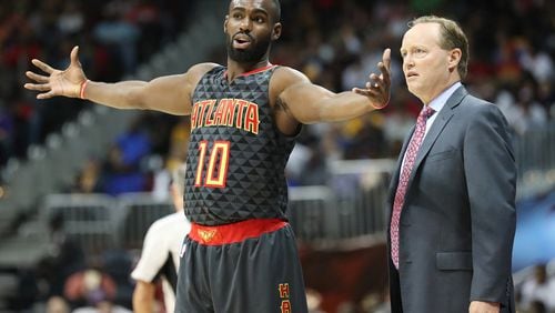Tim Hardaway Jr. confers with head coach Mike Budenholzer during the first period against the Lakers in an NBA basketball game at Philips Arena on Wednesday, Nov. 2, 2016, in Atlanta. Curtis Compton /ccompton@ajc.com