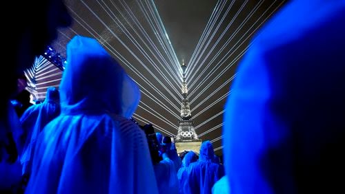 Flashes of lights illuminate the Eiffel Tower in Paris, France, during the opening ceremony of the 2024 Summer Olympics, Friday, July 26, 2024. (AP Photo/Robert F. Bukaty)