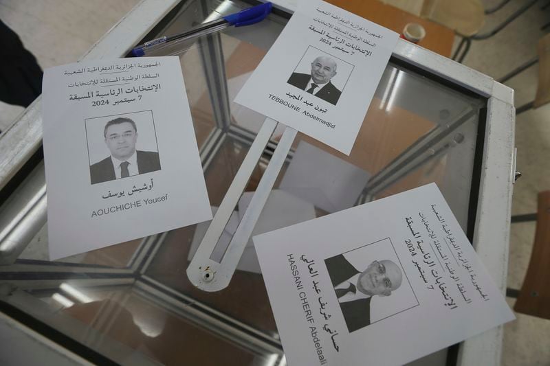 Ballots showing the three presidential candidates are placed on a table inside a polling station during the presidential election, Saturday, Sept. 7, 2024, in Algiers, Algeria. (AP Photo/Anis Belghoul)