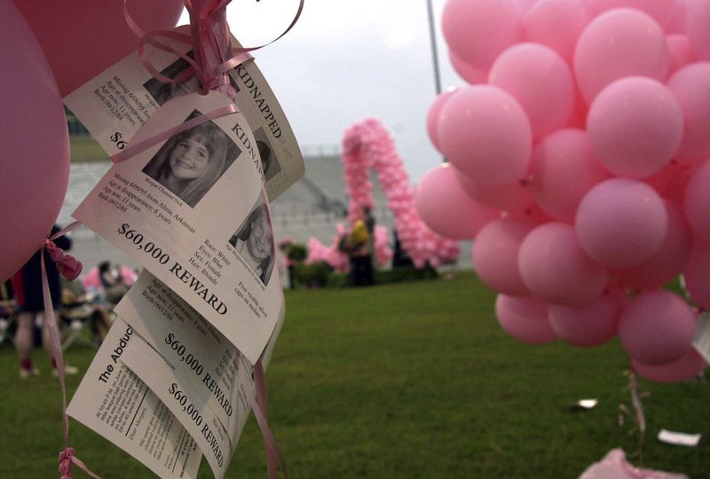 FILE - Notices of the kidnapping of Morgan Nick hang from balloons during the One Hope 2000 ceremony in Alma, Ark., June 3, 2000. (AP Photo/April L. Brown, File)