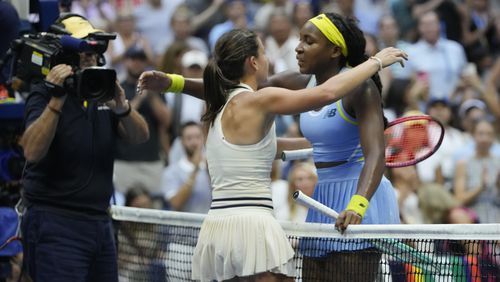 Emma Navarro, center, of the United States, embraces Coco Gauff, of the United States, after defeating her in the fourth round of the U.S. Open tennis championships, Sunday, Sept. 1, in New York. 2024. (AP Photo/Pamela Smith)