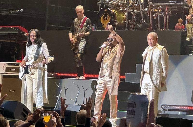 The original members of Earth, Wind & Fire (L-R) Verdine White, Philip Bailey and Ralph Johnson acknowledge the crowd during their concert at Ameris Bank Amphitheatre in Alpharetta Aug. 19, 2024. RODNEY HO/rho@ajc.com