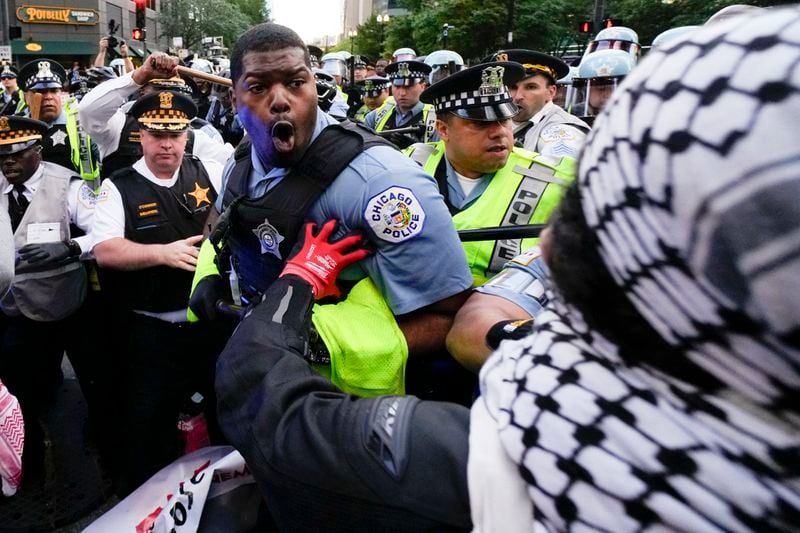 Demonstrators clash with police near the Israeli Consulate during the Democratic National Convention Tuesday, Aug. 20, 2024, in Chicago. (AP Photo/Julio Cortez)