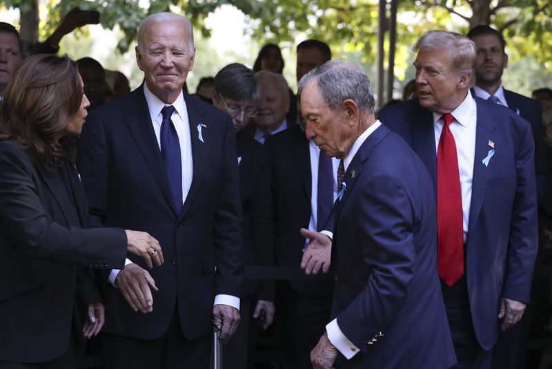 Democratic presidential nominee Vice President Kamala Harris, far left, greets Republican presidential nominee former President Donald Trump, far right, as President Joe Biden and Michael Bloomberg look on upon arriving for the 9/11 Memorial ceremony on the 23rd anniversary of the Sept. 11, 2001 terror attacks, Wednesday, Sept. 11, 2024, in New York. (AP Photo/Yuki Iwamura)