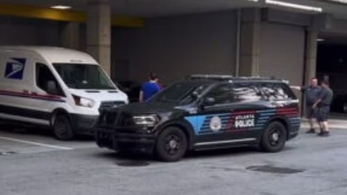 Atlanta police investigated after an armed robbery suspect allegedly exchanged gunfire with a passerby at a Buckhead condo building's loading dock.