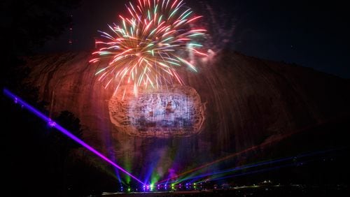 Fireworks explode during the laser show at Stone Mountain Park last April. Fireworks and the popular laser show will also be held for visitors during the Fourth of July celebration, which has been extended. STEVE SCHAEFER / SPECIAL TO THE AJC