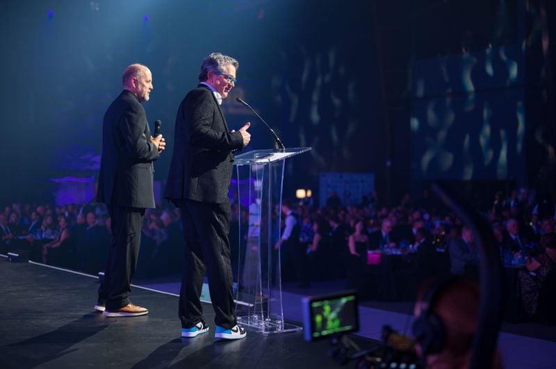 Ron Parker and Frank Patterson, top executives at Trilith, at the podium for Trilith's annual charity gala on March 3, 2023. CONTRIBUTED