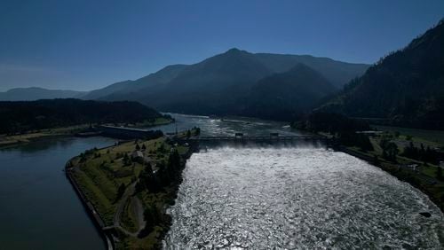 FILE - Water spills over the Bonneville Dam on the Columbia River, which runs along the Washington and Oregon state line, June 21, 2022. The U.S. and Canada said Thursday, July 11, 2024, that they have agreed to update a six-decade-old treaty that governs the use of one of North America’s largest rivers, the Columbia, with implications for electricity prices, irrigation, flood control and imperiled salmon runs. (AP Photo/Jessie Wardarski, File)