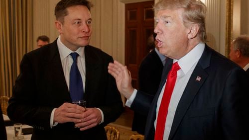 FILE - President Donald Trump (right) talks with Tesla and SpaceX CEO Elon Musk at the White House in Washington, Feb. 3, 2017. (AP Photo/Evan Vucci, File)