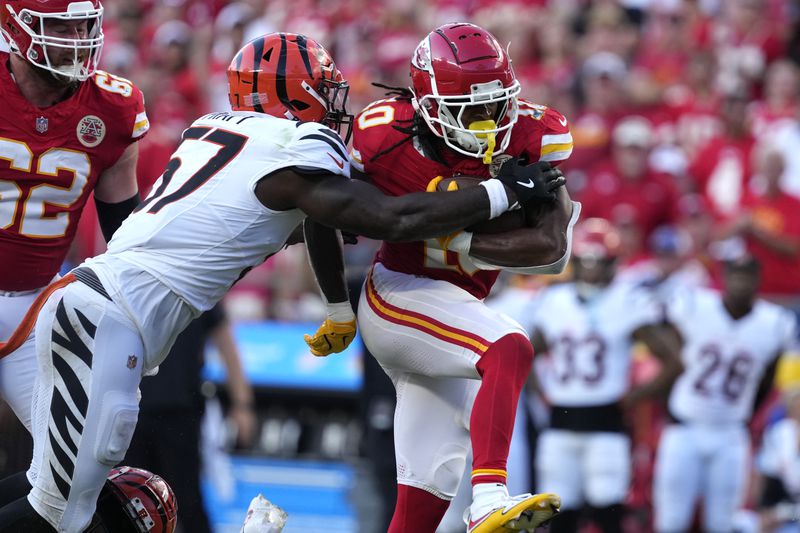 Kansas City Chiefs running back Isiah Pacheco, right, runs with the ball as Cincinnati Bengals linebacker Germaine Pratt (57) defends during the second half of an NFL football game Sunday, Sept. 15, 2024, in Kansas City, Mo. (AP Photo/Ed Zurga)