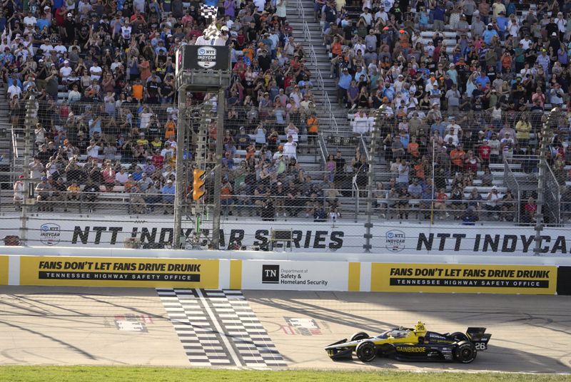 Colton Herta crosses the finish line to win an IndyCar auto race Sunday, Sept. 15, 2024, at Nashville Superspeedway in Lebanon, Tenn. (AP Photo/Mark Humphrey)