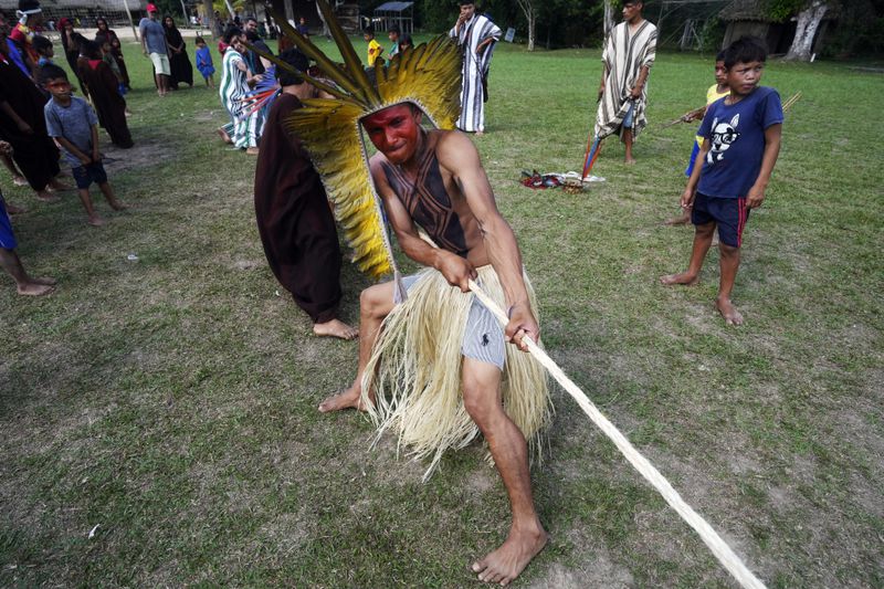 Charles Apolima participates in tug-of-war during the annual celebration recognizing the Ashaninka territory in the Apiwtxa village, Acre state, Brazil, Sunday, June 23, 2024. (AP Photo/Jorge Saenz)